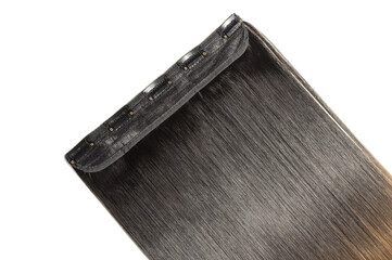 close up texture of single piece clip in straight black blended to honey blonde two tone ombre...