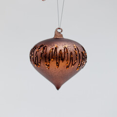 Bronze bulb-shaped Christmas tree toy covered with zigzag patterns and tiny beads