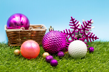 Golf Christmas Decoration with golf ball and Christmas ornament are on green grass