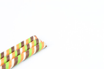 Fototapeta na wymiar Biscuit sticks with chocolate stripes on a white background