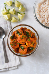 Top view spicy hot Bengali Prawn roast , shrimp masala Kerala fish curry. Indian food. Fish fry with red chili, curry leaf. Asian cuisine. Delicious  Goan fish curry clay pot. Grilled tiger shrimps