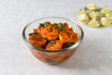 Top view spicy hot Bengali Prawn roast , shrimp masala Kerala fish curry. Indian food. Fish fry with red chili, curry leaf. Asian cuisine. Delicious  Goan fish curry clay pot. Grilled tiger shrimps