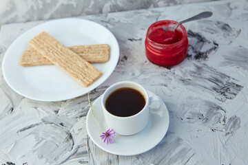 Crispbread with jam for Breakfast on a gray background. A jar of Fresh Honey with foam is next to a Cup of coffee. A minimum of calories. proper nutrition