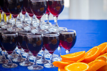 Slices of oranges and wine glasses served in a row up each other