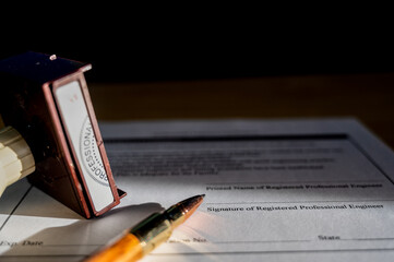 Selective focus on generic professional engineer, architecture. or surveyor stamp and certification statement