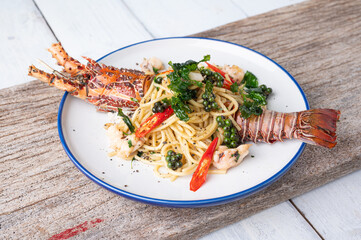 Spaghetti with spicy lobsters in white plate