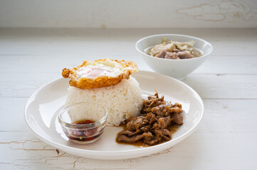 Fried Pork with Garlic, Pepper and fried egg on rice. Easy thai food.