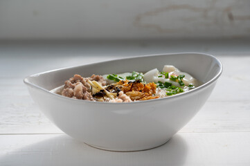 Thai style clear soup rice noodle in traditional bowl. Selective focus