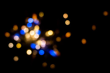 Perfect bokeh for a festive New Year and Christmas background. Defocused abstract yellow and blue light