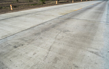 Fototapeta premium Concrete pavement road with longitudinal joint and construction joint.Empty concrete road. 