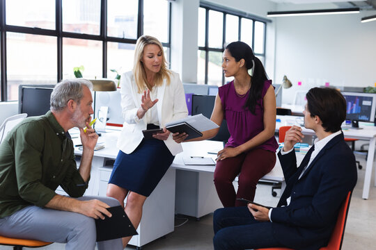Group of diverse business people brainstorming in modern office
