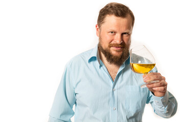 Solid bearded man in shirt tasting whisky studio portrait