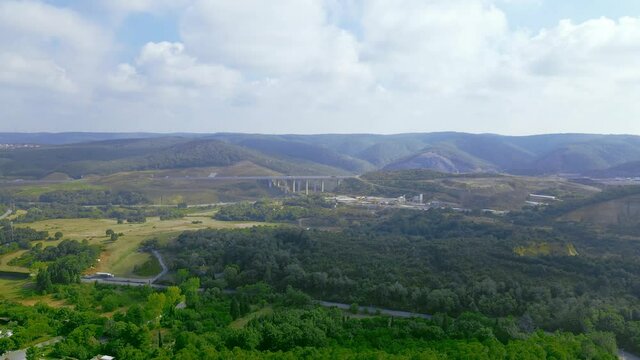4K viaduct above the forest landscape with blue sky. Beautiful nature view.