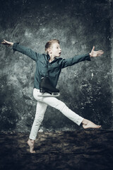 Young figure skater dressed in white jeans and blue shirt