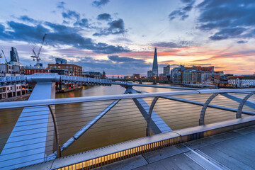 London skyline at sunrise seen from Millenium bridge. England 
