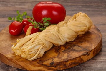 Caucasian traditional pigtail cheese served tomatoes