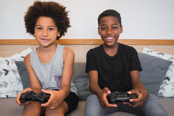 Two brothers playing video games at home. © Mego-studio