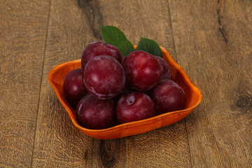 Plum heap in the wooden basket