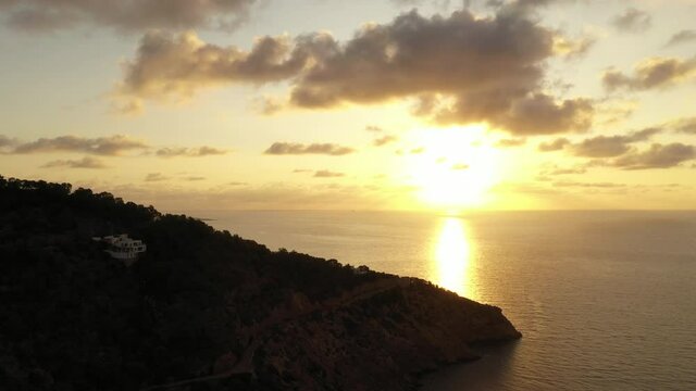 Aerial view of Cala Llonga beach, located in southern Ibiza, Spain. Beautiful aerial view of the bay at sunset