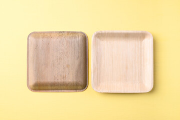 Back and front betal palm leaf plate (Biodegradable, Compostable, Disposable or Eco friendly plate) on yellow background, Sustainable concept