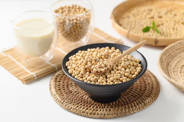 Soybeans seed in a black bowl with spoon and soy milk in a glass, Healthy food