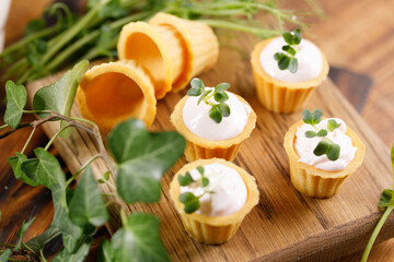 Canapes with light cream filling. Still life with microgreens. The concept of an appetizing snack.
