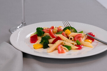 Selective focus and close up of delicious looking pasta and vegetables on a plate on a table. Healthy food and pasta concept.
