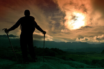 silhouette of a person in the mountains