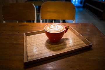 Perfectly served coffee on the wooden table background