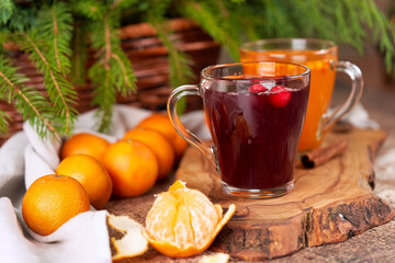 Tangerines and mulled wine in transparent mugs on the christmas table