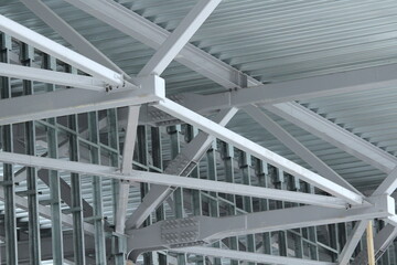 An old steel metal farm. structure of metal structure of frame-type industrial building. Lightweight metal frame construction.