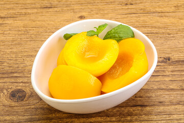 Sweet ripe canned peaches with mint