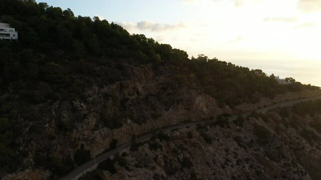 Aerial view of Cala Llonga beach, located in southern Ibiza, Spain. Beautiful aerial view of the bay at sunset