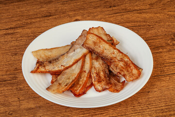 Roasted juicy bacon in the plate