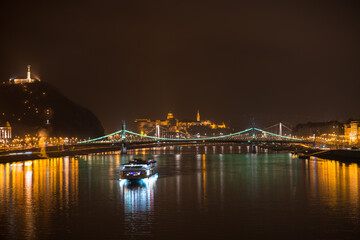 Fototapeta na wymiar Buda Castle and Liberty bridge illuminated at night. Night skyline of Budapest. Hungary 
