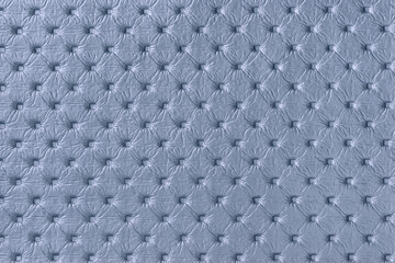 Texture of light blue leather background with capitone pattern, macro.