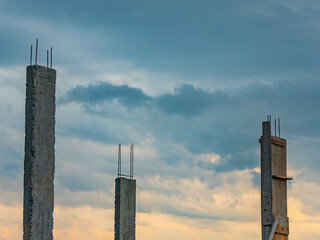 Initial stage of a construction with the cloudy sky in the background. The pillars (pilasters) are...