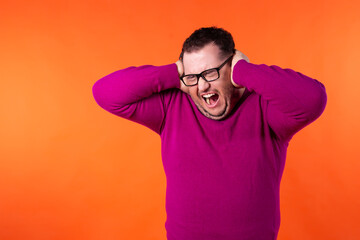 Fototapeta na wymiar Fear and excited face. Young handsome man with beard wearing casual sweater and glasses. Afraid and shocked with surprise and amazed expression. 