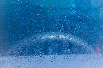 Water rain drops blue Vintage on glass wall on car rain drops on clear window or rain droplets on glass Of Raindrops Or Vapor Trough Window Glass Water droplets blue and Rain droplets
