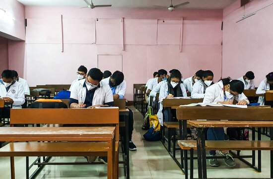 December 10, 2020. Siliguri, West Bengal India. Medical Students In Mask And White Coat Giving Exam As Classes Reopen After Covid 19 Lockdown In West Bengal, India