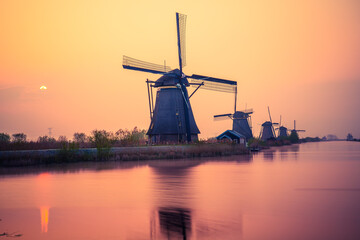 Traditional Dutch windmill at sunset in Kinderdijk. Netherlands 