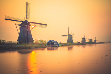 Traditional Dutch windmill at sunset in Kinderdijk. Netherlands 