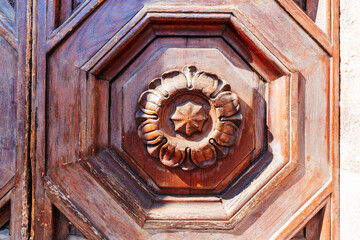 Wood carving pattern background on a vintage wooden door