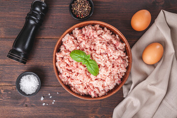 Raw minced meat in bowl on wooden table