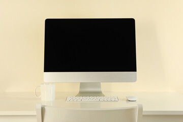 Minimalist workspace concept with desktop computer on beige background