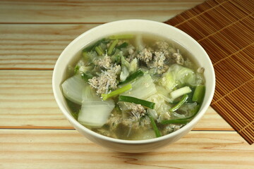 Clear soup of cutting Chinese cabbage mixed with minced pork and fresh spring onion in the bowl. Famous traditional soup menu in Asia restaurant.