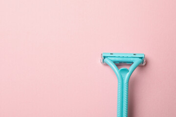 Mint razor on pink background, space for text