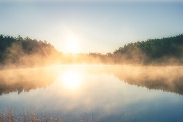 Obraz na płótnie Canvas Sunrsise at the lake with morning fog
