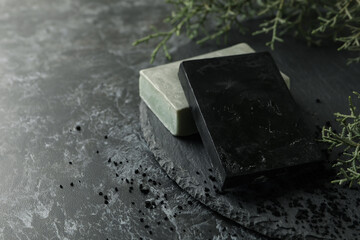 Fototapeta na wymiar Tray with natural handmade soap on black smokey background
