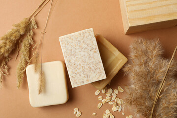 Concept of personal hygiene with different soap on brown background